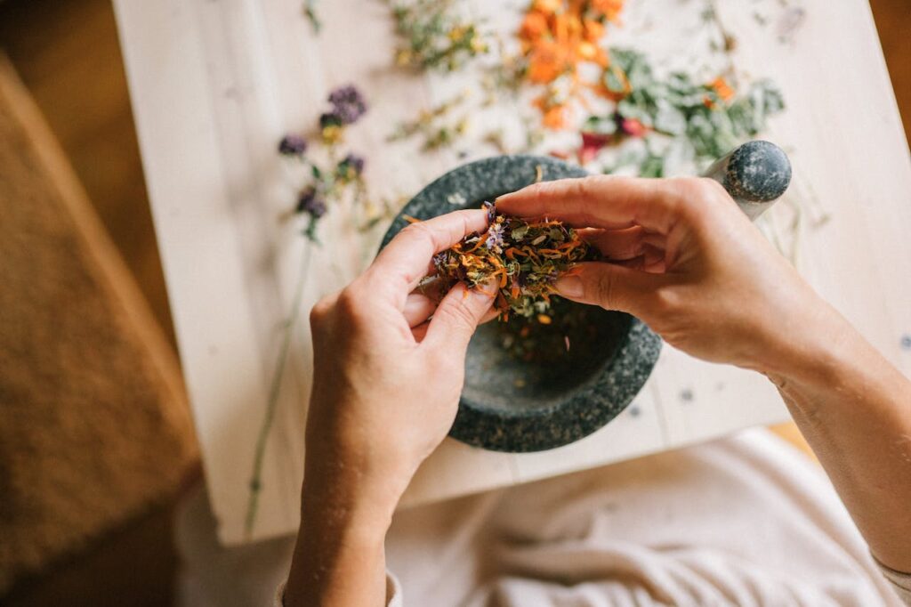 Top View of Woman Mixing Herbs in Mortar